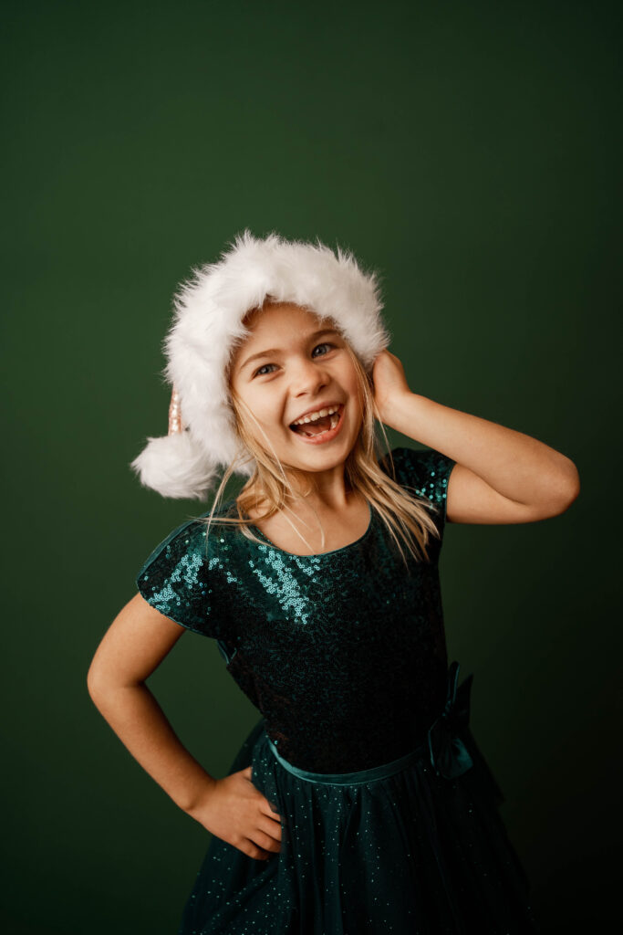 girl dressed in santa hat for christmas portraits in rio, wi