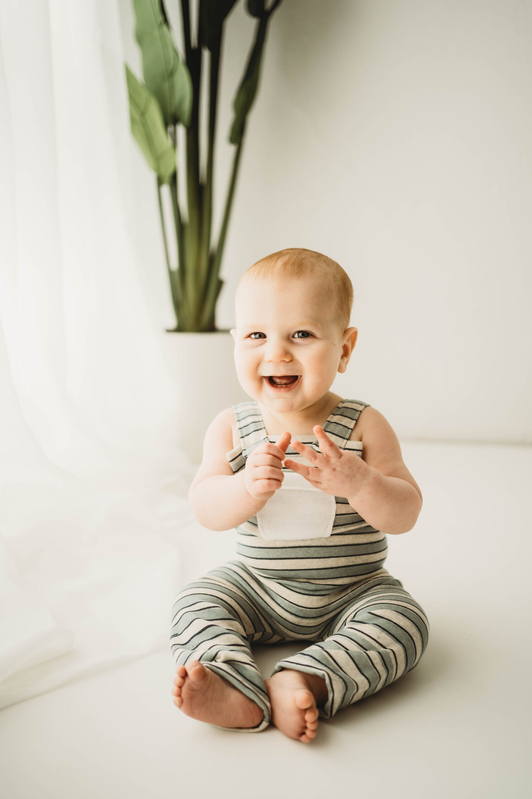 BABY IN STRIPED OVERALLS IN PARDEEVILLE PHOTO STUDIO