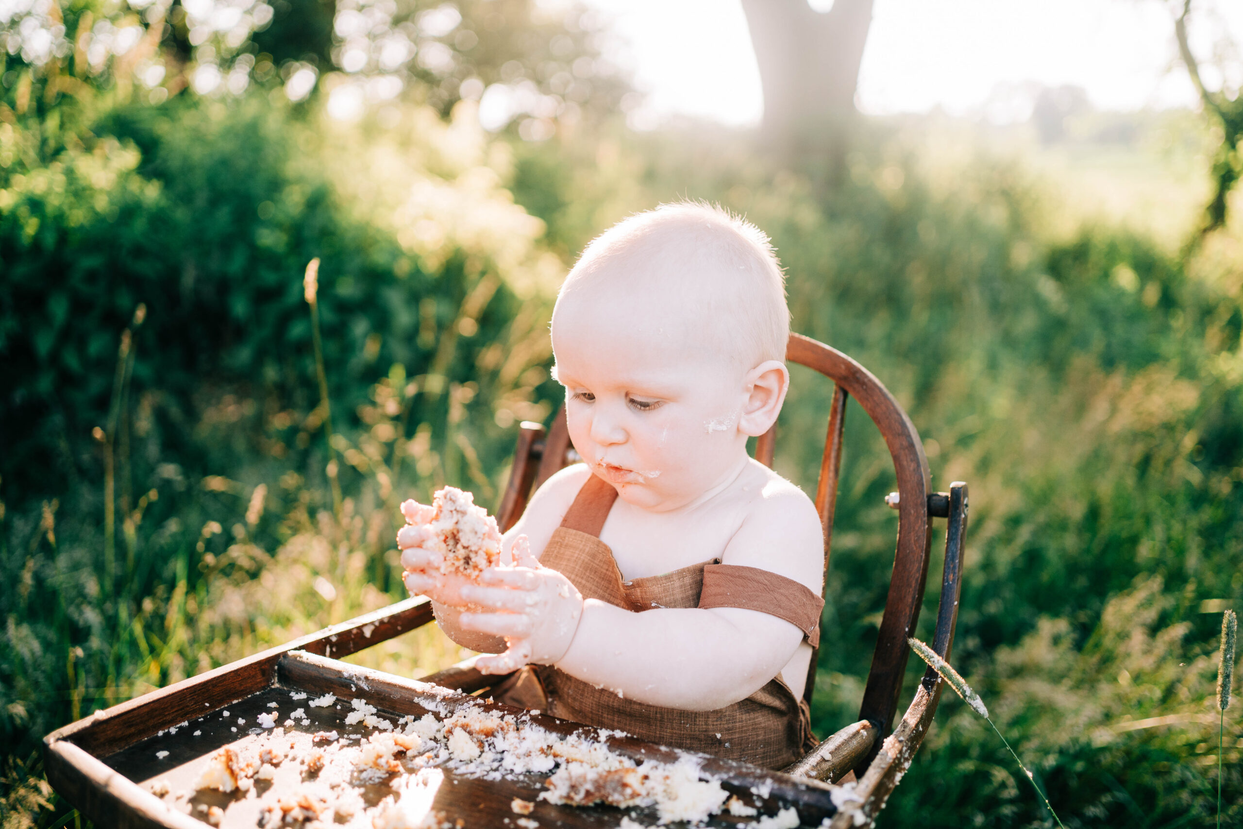 one year old celebrating their first birthday with a one year cake smash and portrait session.