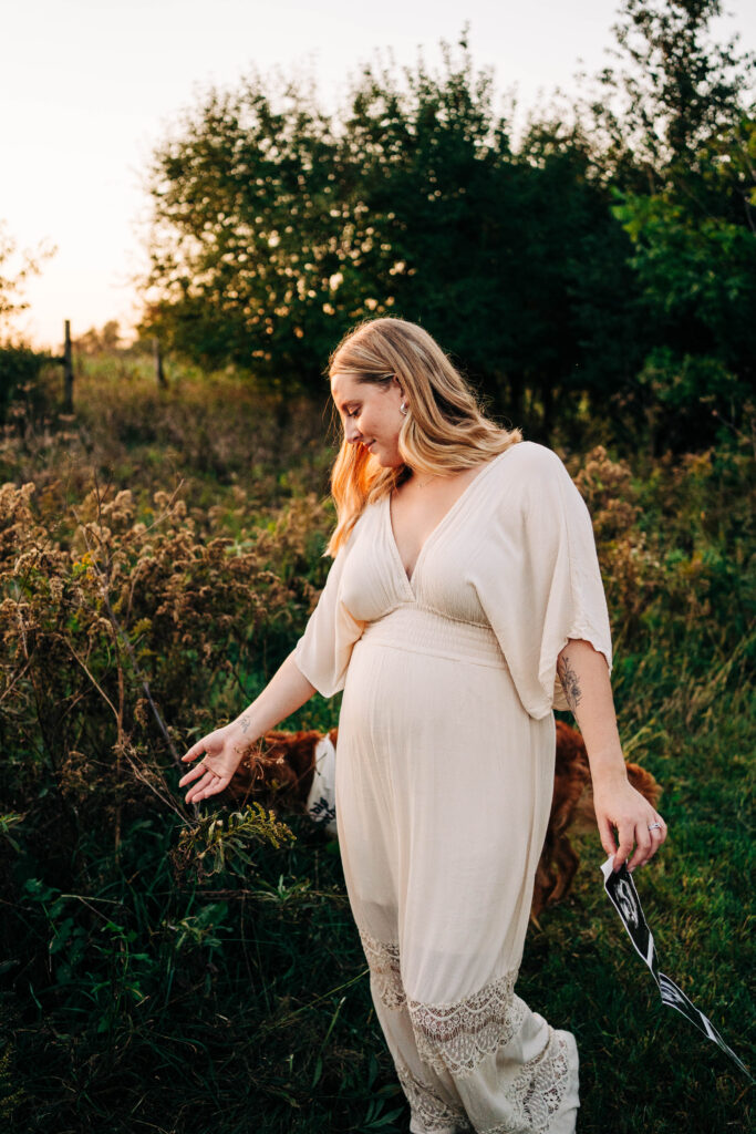 Expecting Mama walking while holding ultrasound pictures, and feeling the Wisconsin Fields