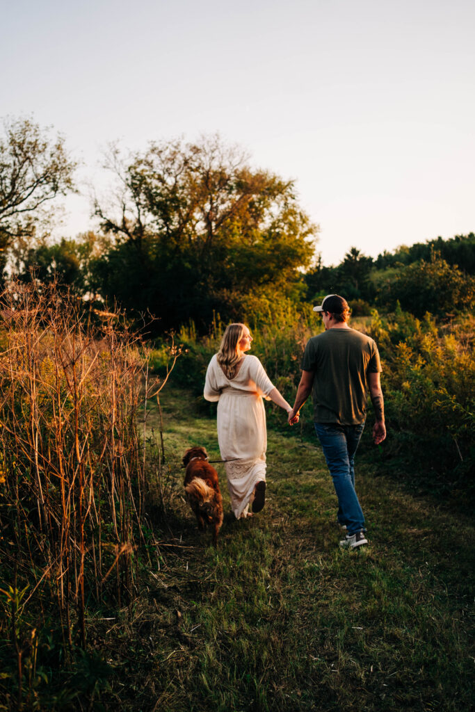 Couple holding hands and walking away from the camera in Madison Wisconsin