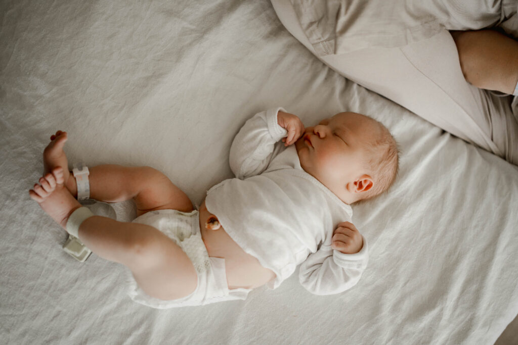 newborn baby laying on a hospital bed during a fresh 48 hospital session near sun prairie wi 
