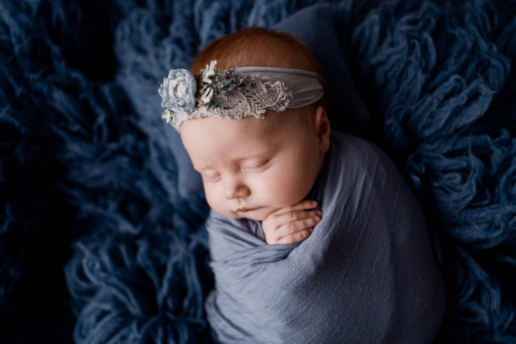 newborn girl in blue for her newborn portraits near sun prairie wi