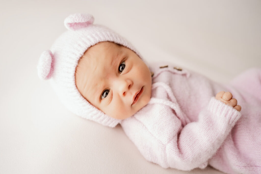 Newborn baby girl looking at the camera in Fond du Lac area newborn Studio
