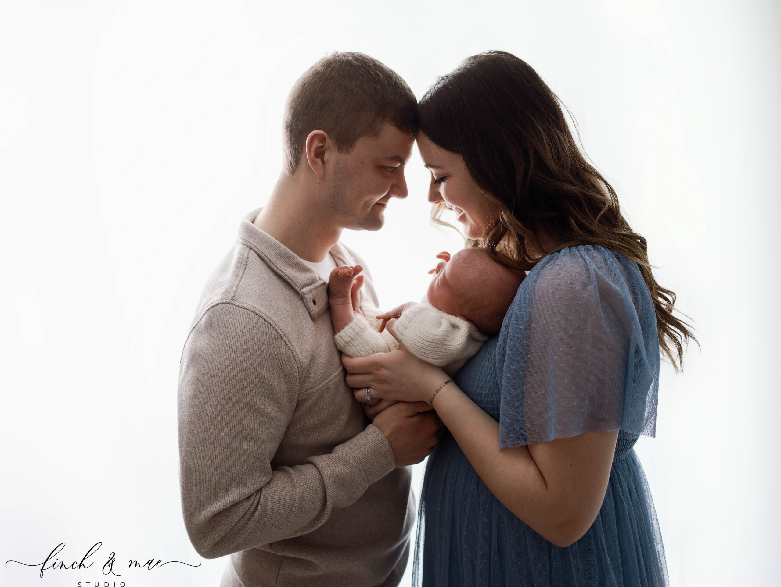 mom and dad holding newborn son in rio, wi newborn portrait studio