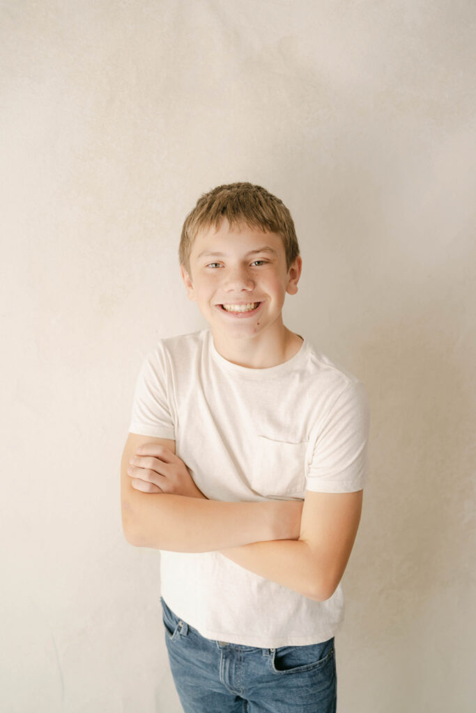 older boy wearing white shirt for a portrait in Rio, WI portrait studio