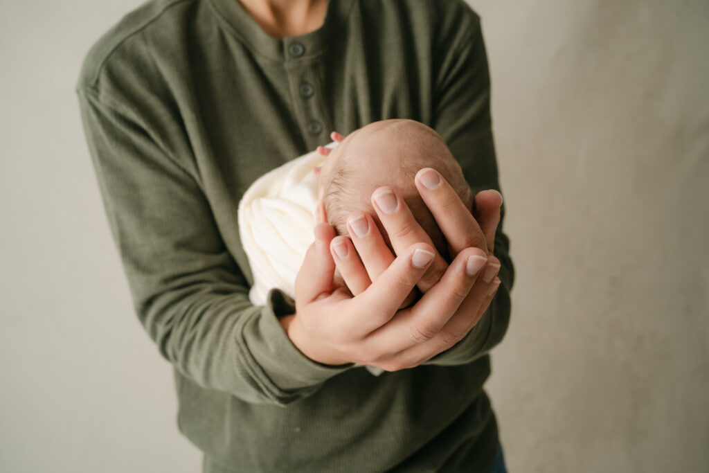 Dad's hands and newborn son - Newborn photography session near Madison, WI