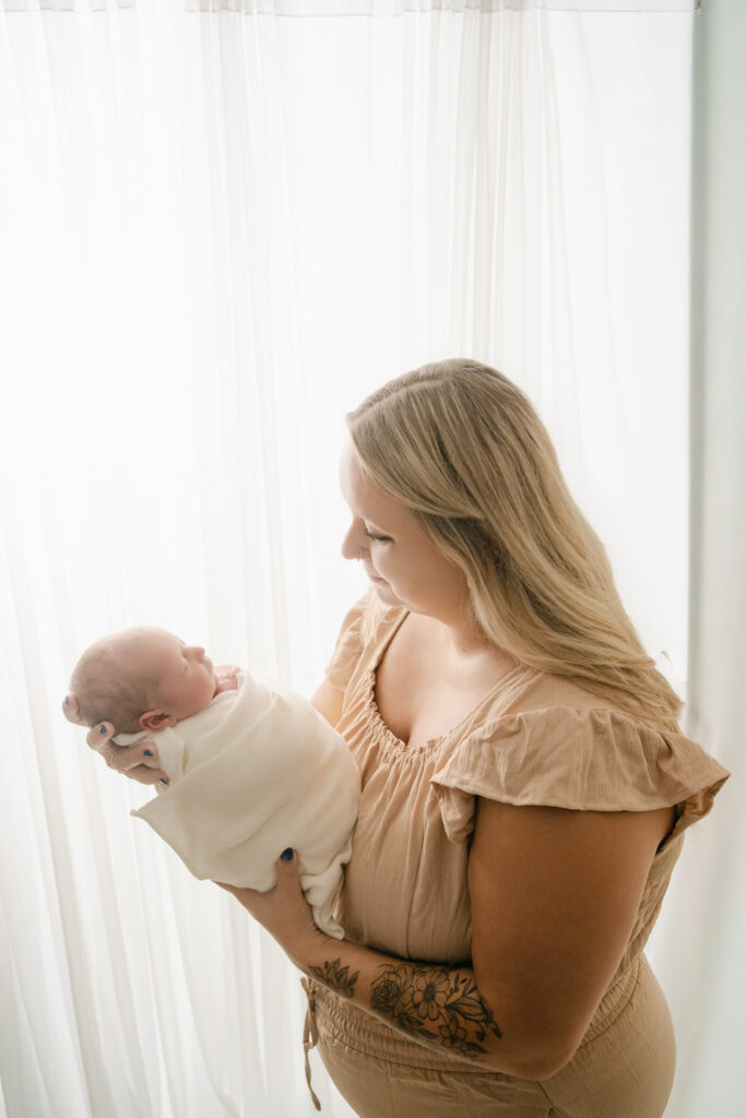 Mom holding newborn son - Newborn photography session near Madison, WI