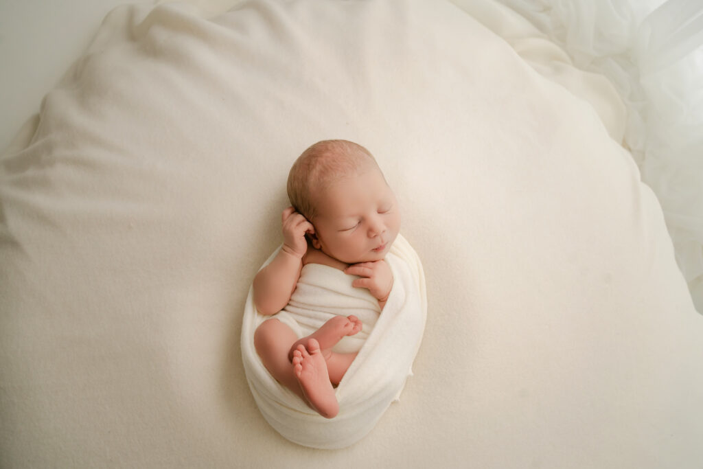 wrapped newborn in white soft wrap - Newborn photography session near Madison, WI